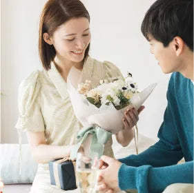 白い花束を嬉しそうに受け取る彼女